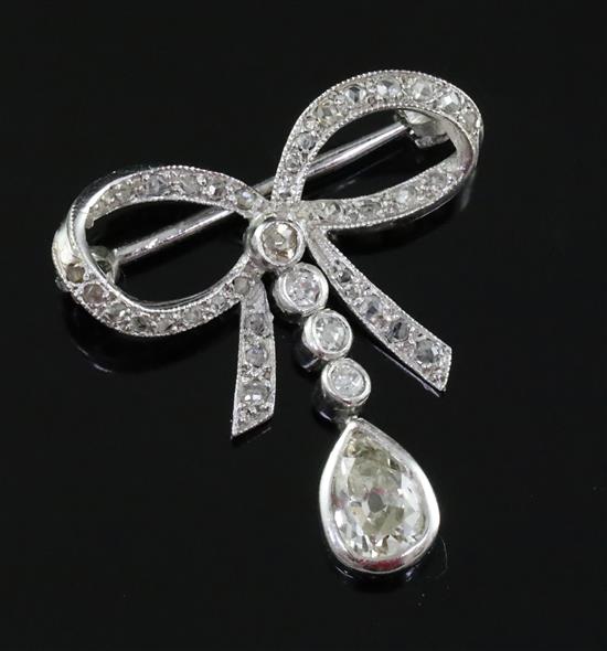 An early 20th century platinum? and diamond drop ribbon bow brooch, width 23mm.